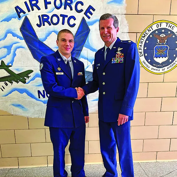 Alex Huffman ‘28 shaking hands with Lt Col Brian O’Connell