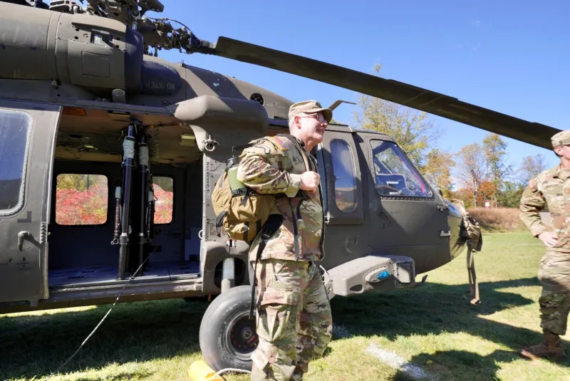 BG Adam Cobb steps off of a Black Hawk Helicopter.