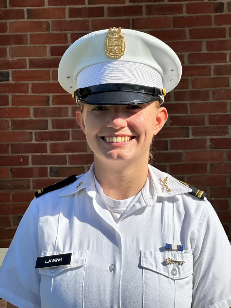 A woman smiles in her white uniform in a standard portrait shot.