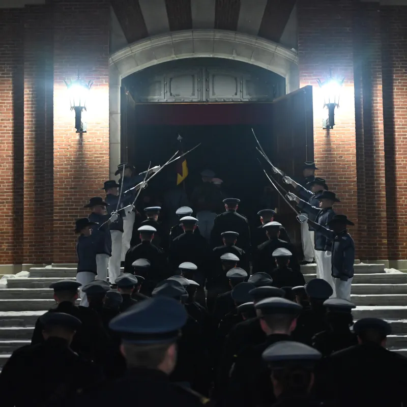 Rooks walk into a building under an archway of drawn swords.