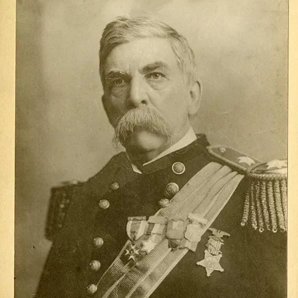 A service member in a decorated military uniform poses for a historical portrait.